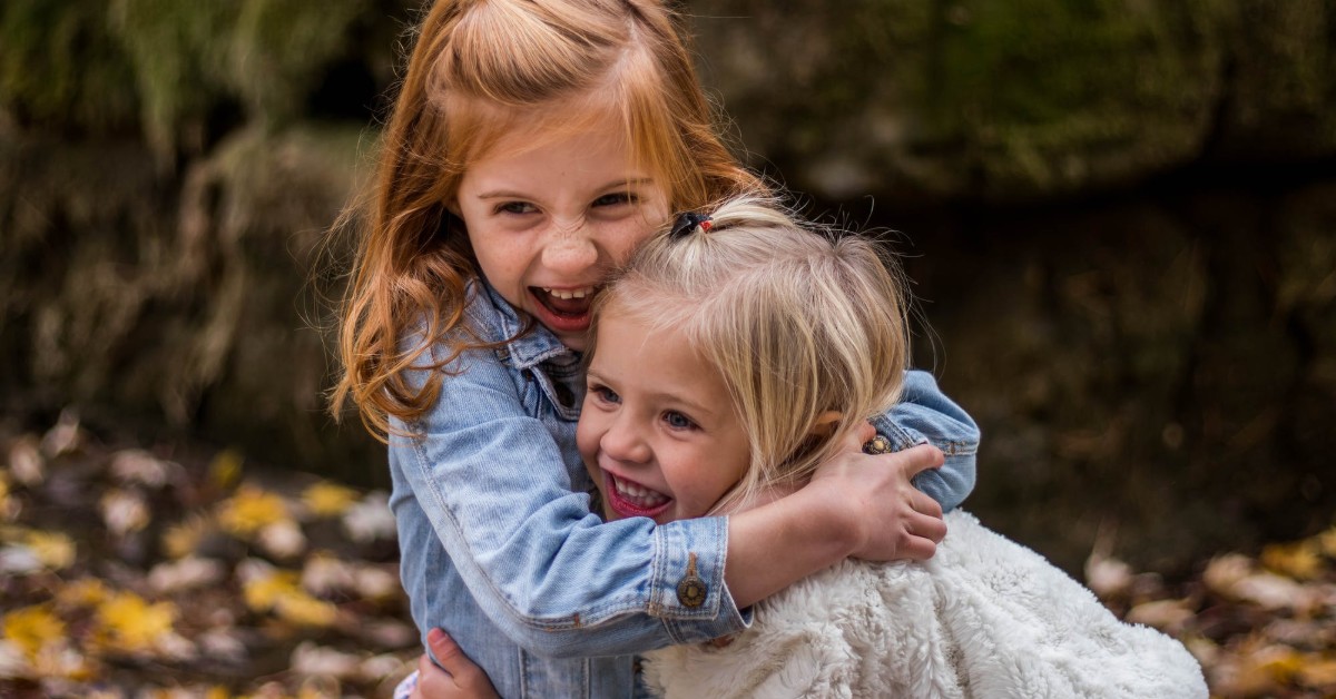 two young girls hugging