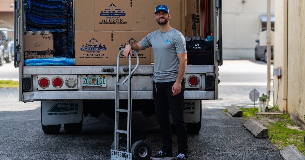 mover standing in front of back of truck