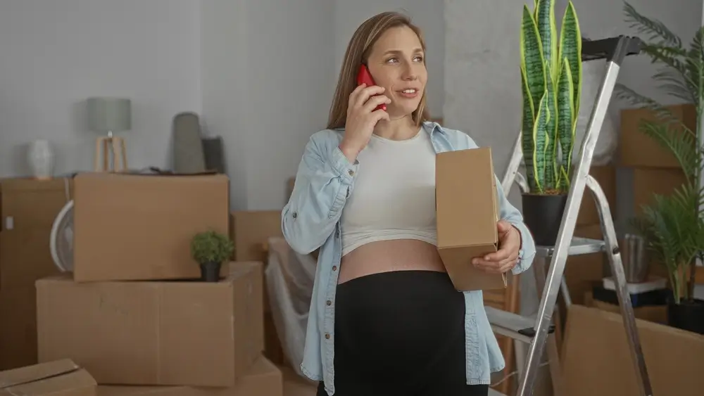 A young couple expecting a baby just moved into an empty apartment unpacking and cleaning.